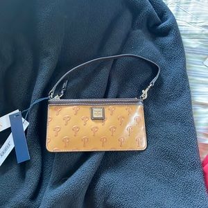 Dooney and bourke phillies wristlet , to small for my phone . Missed return date